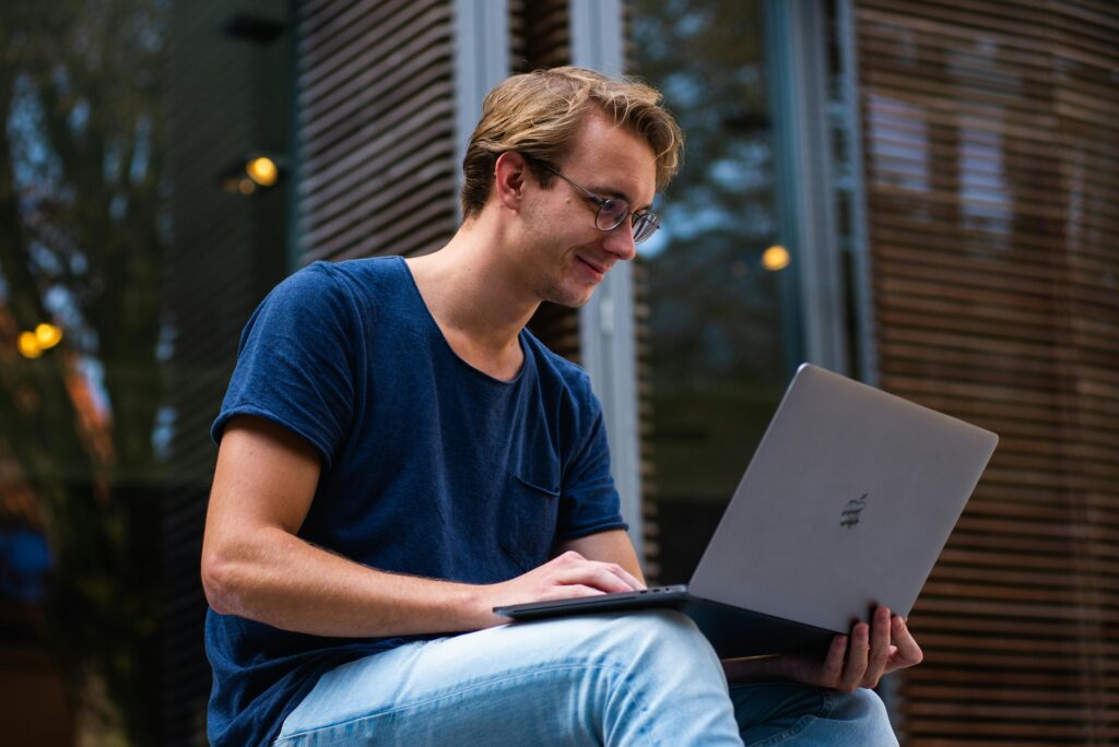 Entrepreneur using AI tools on a laptop to create a startup business.