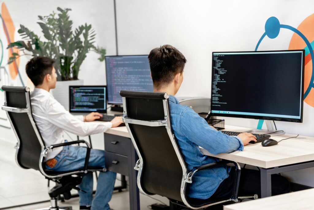 Men using Chat GPT to help build digital projects.